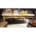 A LARGE PINE RECTANGULAR PLANK TOPPED KITCHEN TABLE, probably 19th century, supported on four turned