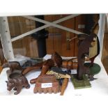 A SELECTION OF NOVELTY WOODEN CARVINGS to include; Grindelwald figural nutcrackers, Black Forest