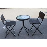 A FOLDING GARDEN TWO PERSON BISTRO SET with circular glazed top table