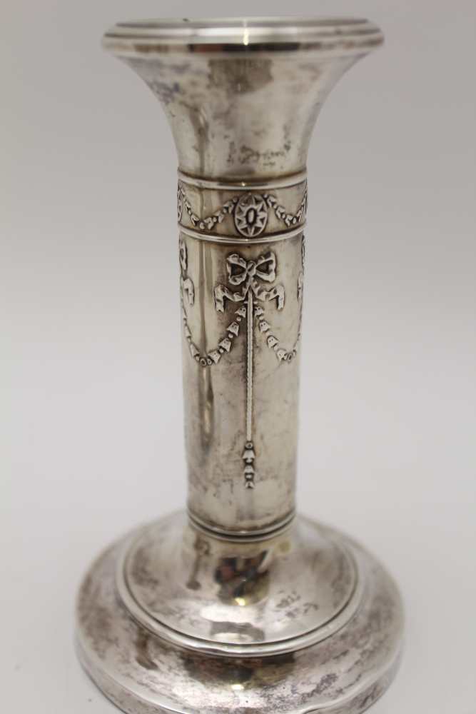 A PAIR OF EDWARDIAN SILVER CANDLESTICKS, embossed ribbon and bell husk swags on circular bases, - Image 3 of 9