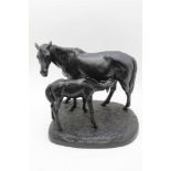 A 20TH CENTURY RUSSIAN SCHOOL CAST IRON MARE & FOAL SCULPTURE, on groundwork base, ebonised