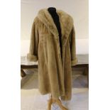 A THREE-QUARTER LENGTH BEAVER FUR COAT with mink collar and cuffs