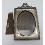 AN EARLY 20TH CENTURY BIRMINGHAM SILVER MOUNTED PHOTOGRAPH FRAME, wreath and ribbon crest, bell husk