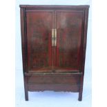 AN ORIENTAL PROBABLE ELM TWO DOOR CABINET with red lacquer front, and chinoiserie scenes of
