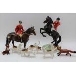 TWO BESWICK MOUNTED HORSEMEN together with six hounds & two foxes (10)