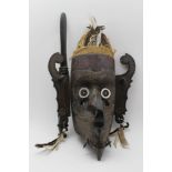 A CARVED WOOD AFRICAN TRIBAL MASK with feathers, 48cm high and a carved wood dagger, with mask