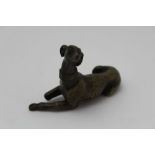 A CAST BRONZE LONG DOG, possibly French, lying down with head up & alert, 6cm high, signs of fixings