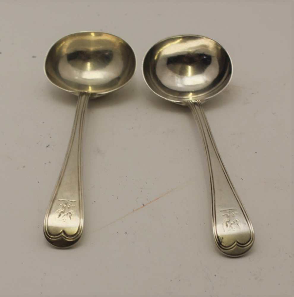 GEORGE ALDWINCKLE A pair of late 19th century silver sauce ladles, engraved with a spread eagle