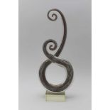 A MURANO GLASS SPIRAL DOUBLE SCROLL SCULPTURE, aventurine inclusions raised on a clear glass block