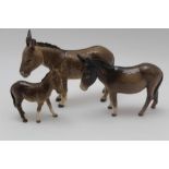 THREE BESWICK DONKEYS, to include a foal (3)