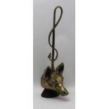 A 20TH CENTURY CAST IRON BACKED MOULDED BRASS DOOR PORTER with fox mask and hunting whip handle,