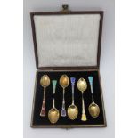 TURNER & SIMPSON, A CASED SET OF SIX SILVER GILT & ENAMEL COFFEE SPOONS, Harlequin of guilloche