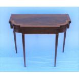 A 19TH CENTURY MAHOGANY FOLD OVER TEA TABLE, satinwood cross handed, raised on squared tapering