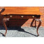 A CONTINENTAL DESIGN SIDE TABLE having associated shaped mahogany top, the base having three