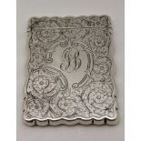WILLIAM M. HAYES, AN EDWARDIAN SILVER VISITING CARD CASE, floral chased decoration, monogrammed,
