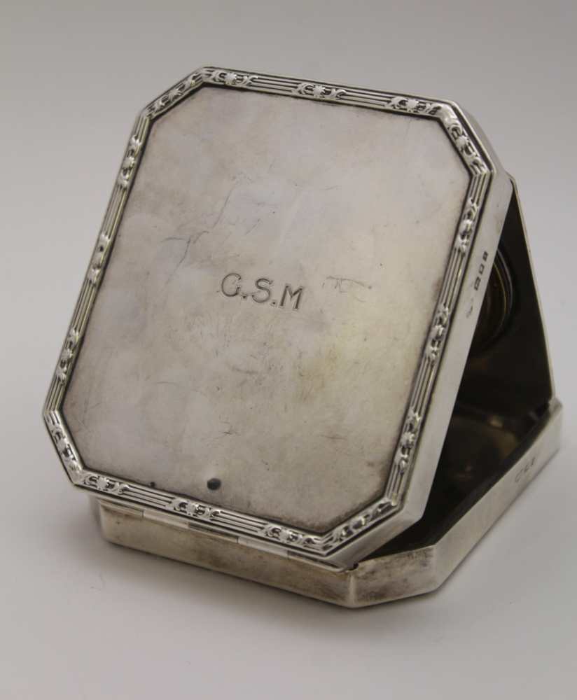 GOLDSMITHS & SIVERSMITH CO. LTD, A SILVER CASED TRAVEL CLOCK, hinged form with bounds reed edge, - Image 2 of 6