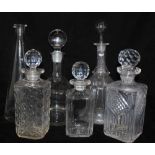 A COLLECTION OF FIVE GLASS DECANTERS AND A CARAFE, various shapes, plain cut and moulded (6)