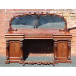 A LATE VICTORIAN MAHOGANY FINISHED BREAK FRONT SIDEBOARD UNIT having arched mirrored plate back with