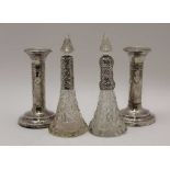 A PAIR OF EDWARDIAN SILVER CANDLESTICKS, embossed ribbon and bell husk swags on circular bases,