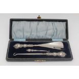 A CASED SILVER HANDLED SET, comprising shoehorn, boot & glove button hooks, embossed bird on a