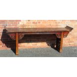 A 19TH CENTURY INDIGENOUS ELM CHINESE LONG ALTER TABLE, the rectangular top having raised ends,