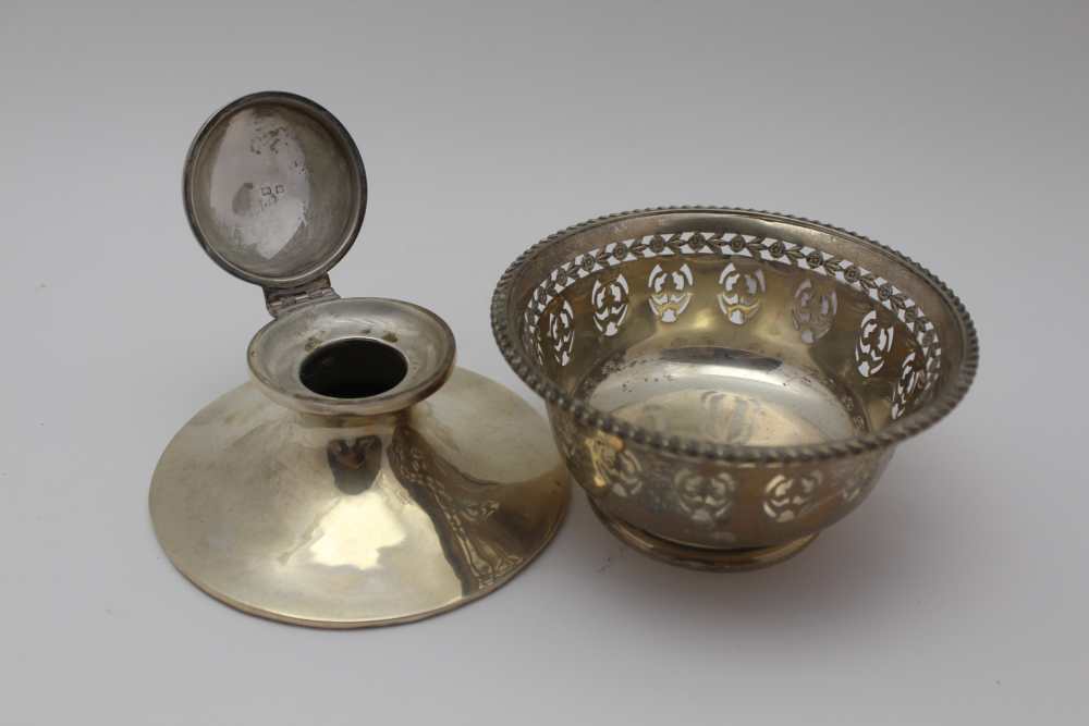 A SILVER CAPSTAN DESIGN INKWELL, hinged cover, base 11.5cm dia, together with a Birks sterling