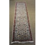 A WOVEN WOOLLEN FLOOR RUNNER with all-over stylised floral decoration, 80cm x 300cm
