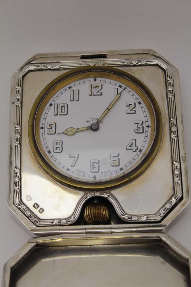 GOLDSMITHS & SIVERSMITH CO. LTD, A SILVER CASED TRAVEL CLOCK, hinged form with bounds reed edge, - Image 5 of 6