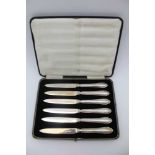 JAMES DEAKIN & SONS A cased set of six silver bladed fruit & tea knives, Sheffield 1931, 141.9g