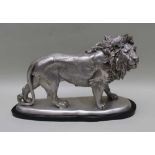 A CAST METAL MALE LION atop a plain plinth base, 29cm high inclusive