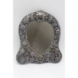 AN EDWARDIAN SILVER MOUNTED HEART SHAPED DRESSING TABLE MIRROR, pierced and embossed floral