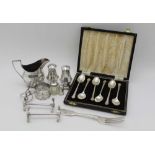 A COLLECTION OF SILVER ITEMS, includes a cream jog, pair of knife rests, condiments, napkin rings,