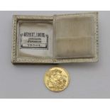 A 20TH CENTURY GOLD FULL SOVEREIGN, in a book form jewellery box