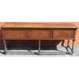 AN 18TH CENTURY OAK DRESSER having twin planked top, over three herring bone crossbanded and