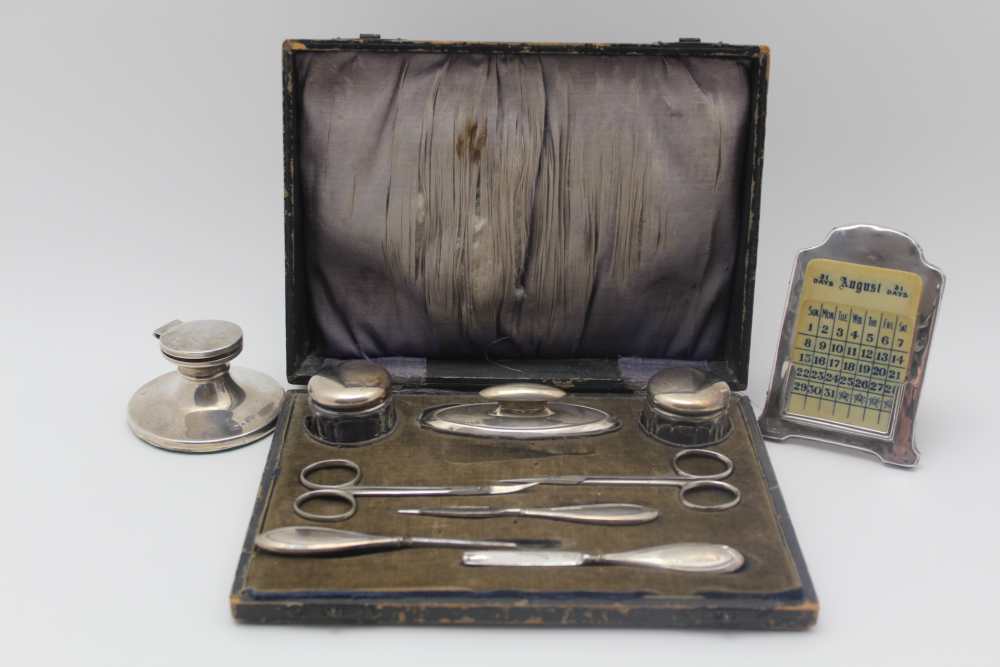 A MANICURE CASE contains a quantity of silver mounted requisites, the nail buffer is hallmarked
