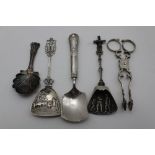 A PAIR OF CAST GEORGIAN SILVER SUGAR TONGS, together with a silver tea caddy spoon, Birmingham 1826,