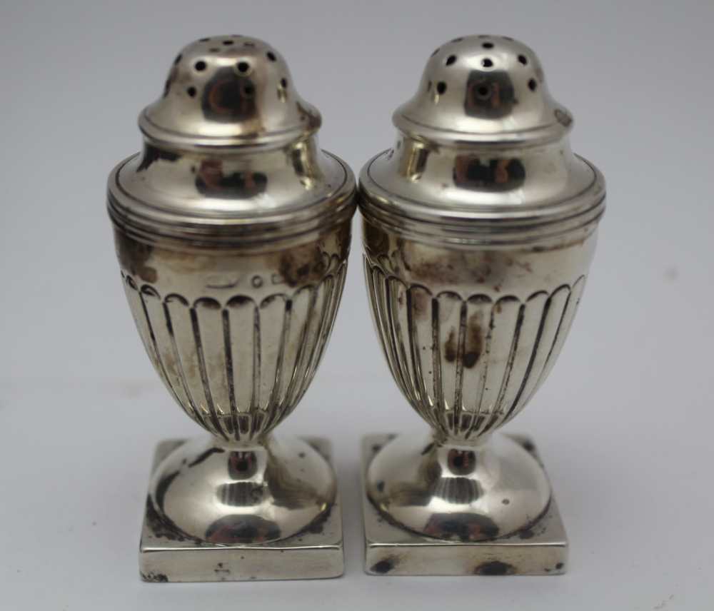 GEORGE UNITE A pair of Victorian silver peppers, of Regency Urn form, fluted bodies raised on square - Image 2 of 4