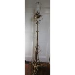 A PROBABLE EARLY 20TH CENTURY ADJUSTABLE BRASS STANDARD LIGHT FITTING, supported on cast claw