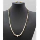 A SINGLE STRAND OF GRADUATED PEARL NECKLACE (considered cultured) 52cm long, and a matching pair