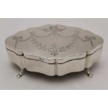 JONES & CROMPTON, A SILVER TABLE CASKET, serpentine form, the hinged lid engraved with ribbon swags,