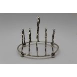 A LATE VICTORIAN SILVER TOAST RACK, oval base raised on four ball feet, Birmingham 1898, 11cm, 66g