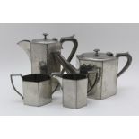 AN ENGLISH PEWTER FOUR PIECE TEASET, beaten surface finish, comprising teapot, hot water pot, milk