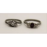 TWO 18CT GOLD LADY'S RINGS, on set three diamonds, one a ruby flanked by two diamonds, one size 'M',