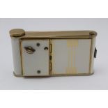 A MID 20TH CENTURY COMBINATION CIGARETTE CASE, COMPACT, LIPSTICK HOLDER, brass and cream panelled