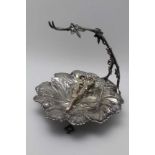 A VICTORIAN SILVER PLATED GRAPE DISH, moulded leaf form with vine arm to support the bunch, raised