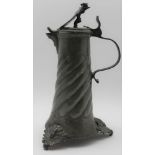 A 17TH CENTURY DESIGN GERMAN PEWTER LIDDED JUG, the hinged cover with mask thumbpiece and heraldic