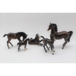 FIVE BESWICK FOALS (four standing and one lying down)