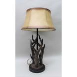 A NOVELTY TABLE LAMP IN THE FORM OF DEER ANTLERS, with parchment effect shade, 62cm high to light