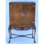 A C. 1960s COCKTAIL CABINET IN THE FORM OF AN ANTIQUE DUTCH CHEST ON STAND, the plain doors