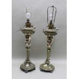 A PAIR OF CONTINENTAL CERAMIC OIL LAMPS, (converted to electricity), the reservoirs & Aladin's
